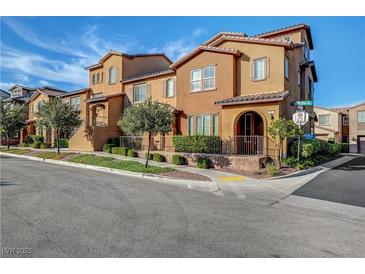 Charming two-story townhome featuring a landscaped yard and a well-maintained front exterior at 11420 Ogden Mills Dr # 101, Las Vegas, NV 89135