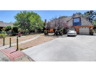 Charming two-story home with well-manicured landscaping and a spacious driveway leading to a two-car garage at 1700 Red Rock St, Las Vegas, NV 89146