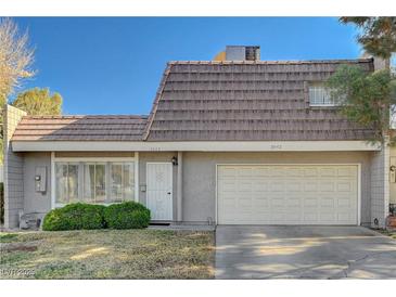 Charming townhome featuring a two-car garage, secure front door, and verdant landscaping, situated on a sunny day at 3642 Haverhill St, Las Vegas, NV 89121