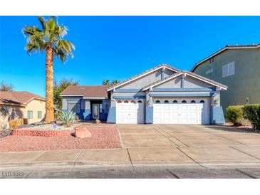 Charming single-story home with a well-manicured lawn, palm tree, and a two-car garage at 52 Vallejo Verde St, Henderson, NV 89012