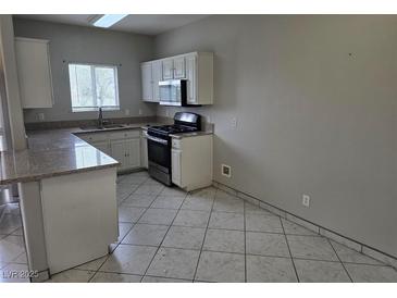 Functional kitchen featuring white cabinets and modern appliances at 5655 E Sahara Ave # 2020, Las Vegas, NV 89142