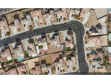 An aerial view showing closely arranged homes in a suburban neighborhood with desert landscaping and swimming pools at 5960 Addy Ln, North Las Vegas, NV 89081