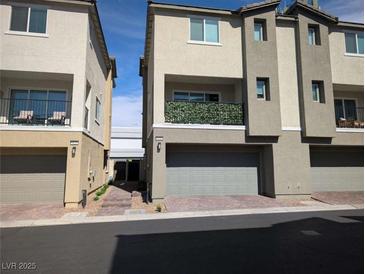 Modern townhome exterior features a neutral color scheme and attached garages at 6830 Truffle Gray St, Las Vegas, NV 89148