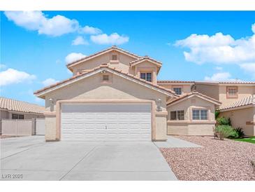 Charming two-story home showcasing a well-maintained front yard and inviting curb appeal with a garage and driveway at 720 Picasso Picture Ct, North Las Vegas, NV 89081
