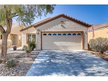 Charming single-story home with a two-car garage and well-maintained desert landscaping at 7669 Fieldfare Dr, North Las Vegas, NV 89084