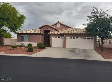Charming single-story home features a two-car garage, desert landscaping, and a tile roof at 9524 Tyler Rose St, Las Vegas, NV 89178