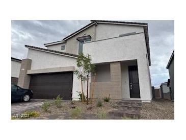 Modern two-story home featuring a neutral color scheme, attached two-car garage, and minimal landscaping at 10204 Kern Peak St, Las Vegas, NV 89166