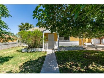 Charming single-story home featuring a well-maintained lawn and a welcoming entrance with a small porch at 1127 Melville Dr, Las Vegas, NV 89102