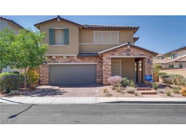 Charming two-story home featuring a stone facade, two car garage, and low maintenance desert landscaping at 253 Kindly Way, Henderson, NV 89011