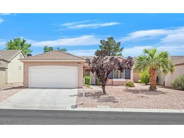 Charming single-story home with a two-car garage, desert landscaping, and mature trees for added curb appeal at 2573 Grandville Ave, Henderson, NV 89052
