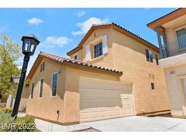 Inviting two-story home featuring an attached two-car garage and desert landscaping at 3526 Harbor Tides St, Las Vegas, NV 89147