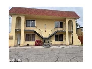 Two story exterior with stairs leading to the second floor and arched entryway at 4150 Solteros St, Las Vegas, NV 89103