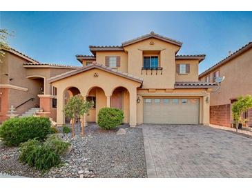 Charming two-story home featuring a stucco exterior, arched entryway, and a well-maintained landscaped yard at 4937 Teal Petals St, North Las Vegas, NV 89081