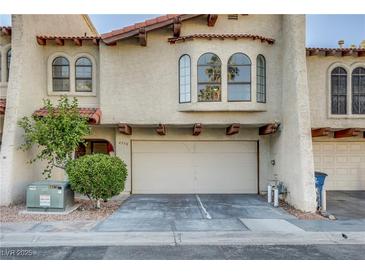 Charming two-story townhome featuring a spacious garage and well-maintained landscaping at 4998 Schumann Dr, Las Vegas, NV 89146