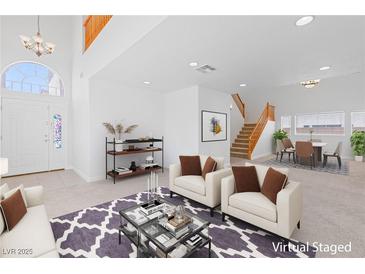 Bright living room with soaring ceilings, a modern rug, and stylish furnishings at 5396 Valley Wells Way, Las Vegas, NV 89113