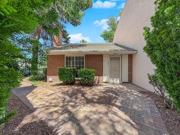 Charming brick home with a tiled roof, mature landscaping, and a welcoming front entrance at 540 Tam O Shanter, Las Vegas, NV 89109