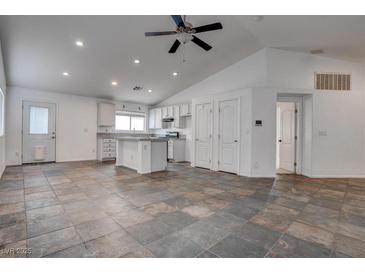 Open floor plan featuring a spacious kitchen with ample cabinets and a kitchen island at 6436 Point Break St, North Las Vegas, NV 89084