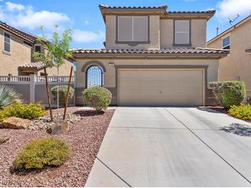 Charming two-story home with a well-maintained front yard and a two-car garage at 1124 Aspen Cliff Dr, Henderson, NV 89011