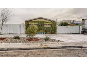Charming home featuring rock landscaping and a unique ivy-covered facade for added curb appeal at 2060 Toiyabe St, Las Vegas, NV 89156