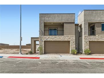 Modern two-story home with a two-car garage and mixed stone and siding facade at 240 White Crest Peak Ave, Henderson, NV 89015