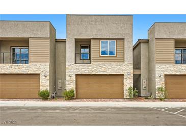 Contemporary townhome features stone accents, private garage, and neutral color palette at 242 White Crest Peak Ave, Henderson, NV 89015