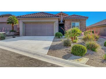 Inviting home featuring a two-car garage and desert landscaping for low maintenance at 2613 Velodrome Ct, Henderson, NV 89044