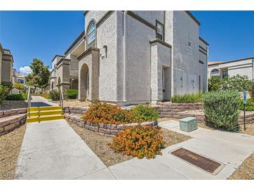 View of the condo building exterior showcasing manicured landscaping and inviting walkways at 3150 Soft Breezes Dr # 1050, Las Vegas, NV 89128