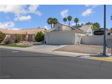 Single story home with desert landscaping and an attached two car garage at 4644 Canna Dr, Las Vegas, NV 89122