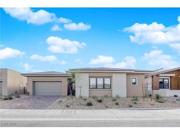 Charming single-story home featuring a neutral color scheme, low maintenance landscaping, and a two-car garage at 11049 Concord Valley Drive, Las Vegas, NV 89135