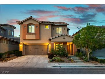 Charming two-story home featuring a well-manicured front yard and a two-car garage in a residential neighborhood at 11228 Hedgemont Ave, Las Vegas, NV 89138