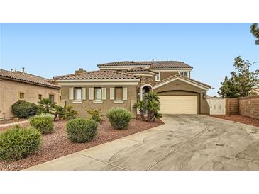 Charming stucco home with a tile roof and a two car garage on a sunny day at 11278 Tenza Ct, Las Vegas, NV 89141