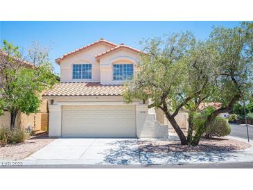 Charming two-story home featuring a well-maintained lawn and a two-car garage at 1620 Western Lily St, Las Vegas, NV 89128