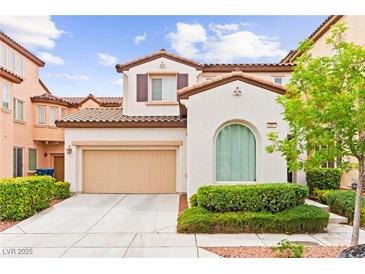 Charming two-story home with a two car garage, manicured landscaping, and a traditional architectural design at 1887 Hollywell St, Las Vegas, NV 89135