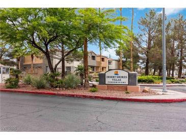 Community entrance with lush landscaping and Desert Shores Villas signage for a welcoming appeal at 3151 Soaring Gulls Dr # 2081, Las Vegas, NV 89128