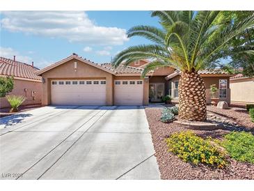Charming single-story home with a well-manicured front yard and attached two-car garage at 3913 Ricebird Way, North Las Vegas, NV 89084