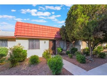 Charming single-story home featuring a red tile roof and well-manicured landscaping at 3925 Torsby Pl, Las Vegas, NV 89119