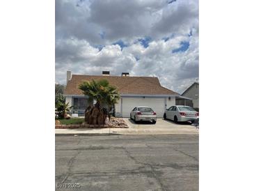Charming single-story home featuring a two-car garage, landscaped front yard and neutral color palette at 4602 Inland Ct, Las Vegas, NV 89147
