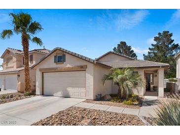Charming single-Gathering home featuring desert landscaping, a two-car garage, and a welcoming front porch at 688 Castlebridge Ave, Las Vegas, NV 89123
