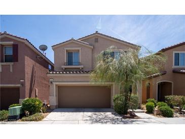 Two-story home features a cozy two-car garage and manicured landscaping at 7715 Peaceful Trellis Dr, Las Vegas, NV 89179