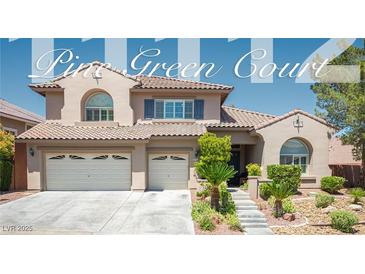 Inviting two-story home featuring a tile roof, a two-car garage, and desert landscaping at 11112 Pine Greens Ct, Las Vegas, NV 89144