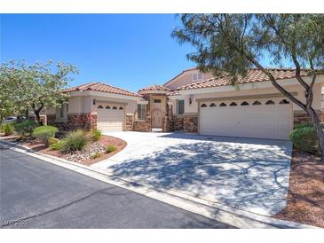 Charming single-story home with tile roof, desert landscaping, and a spacious three-car garage at 1963 Dakota Lodge Ave, Las Vegas, NV 89123