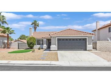Charming single-story home featuring a two-car garage, landscaped front yard, and a classic tile roof at 540 Kelsford Dr, Las Vegas, NV 89123
