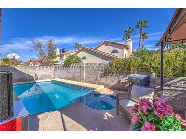 Sparkling pool and spa with patio area perfect for outdoor entertaining and lounging under the sun at 6408 Deadwood Rd, Las Vegas, NV 89108