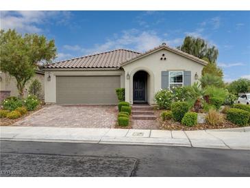 Charming single-story home with a tiled roof, two-car garage, and manicured landscaping at 7052 Blissful Peak St, North Las Vegas, NV 89084