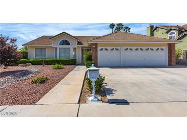 Charming single-story home featuring a well-manicured lawn and a two-car garage at 8761 Anchor Point Ave, Las Vegas, NV 89117