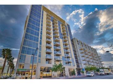 Striking exterior of a high-rise condo building with sleek glass facade and private balconies at 353 E Bonneville Ave # 555, Las Vegas, NV 89101