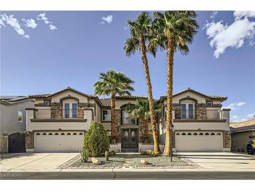 Stunning two-story home featuring a three-car garage, balconies, and meticulously manicured front yard with palm trees at 386 Wiseton Ave, Las Vegas, NV 89183