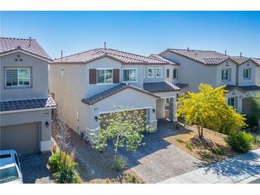 Inviting two-story home with a well-manicured front yard and a charming, neutral-toned exterior at 4634 Observed St, North Las Vegas, NV 89031