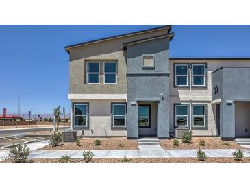 Modern two-story home featuring a stylish two-tone exterior, well-manicured landscaping, and ample natural light at 6105 Aster Garden St # 160, North Las Vegas, NV 89081