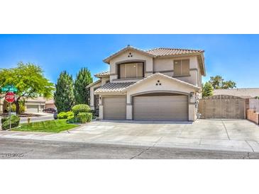 Stunning two-story home featuring a three-car garage, desert landscaping, and neutral color palette at 6301 Citrine Ave, Las Vegas, NV 89130